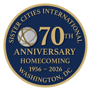 Circular seal image with Sister Cities International logo and these words: Sister Cities International 70th Anniversary Homecoming 1956-2026 Washington, DC.